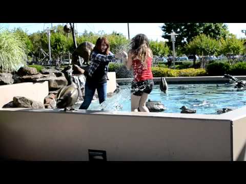 Girls Playing In Public Fountain