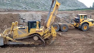Volvo A45G articulated haulers dumping Rock  D8T Dozer pushing