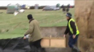 Hare coursers moving box of hares into back of a van