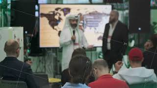 Business conference presentation with speaker and attentive audience in modern seminar setting