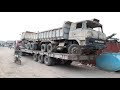 Mercedes long trailer unloading Mitsubishi trucks