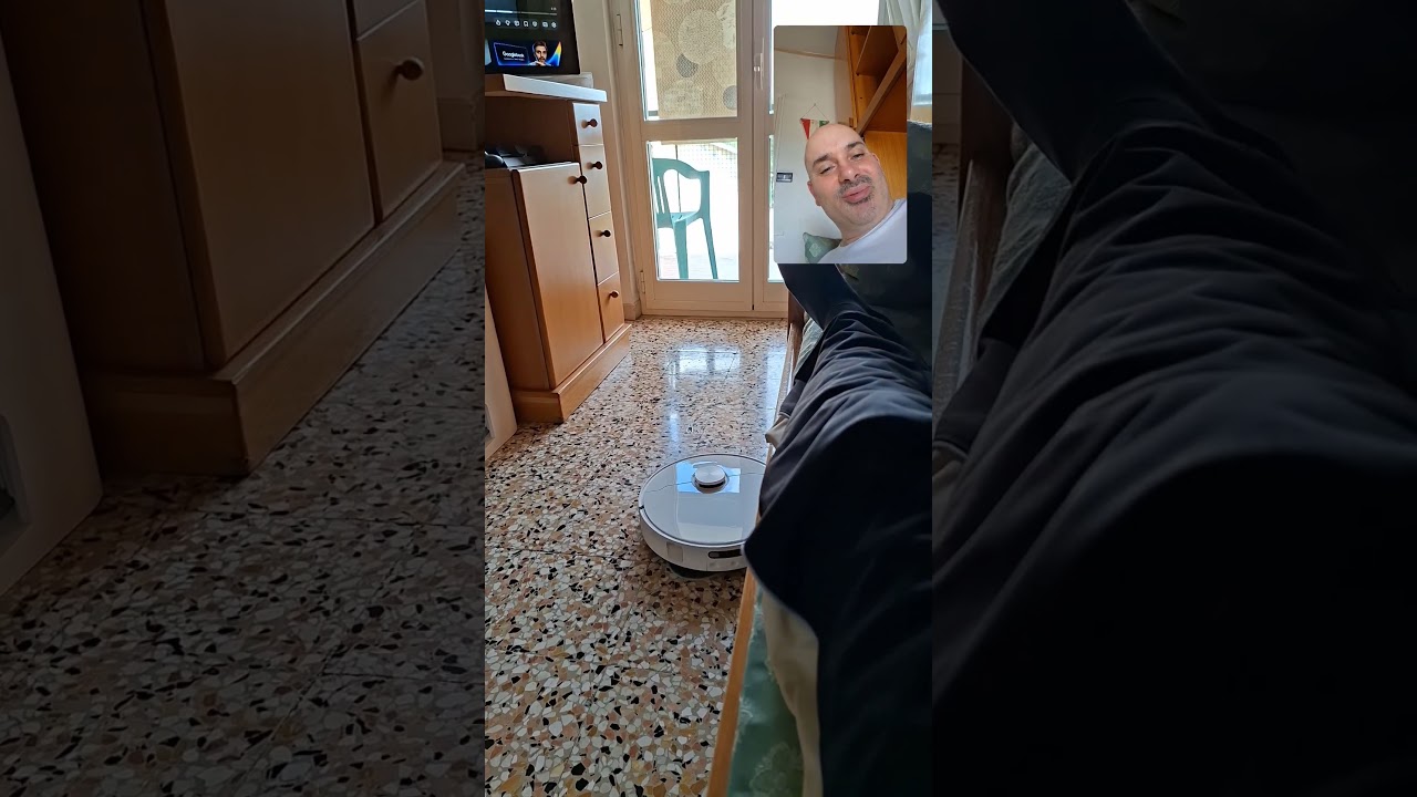 Stravaccato sul letto mentre il robot pulisce la stanza