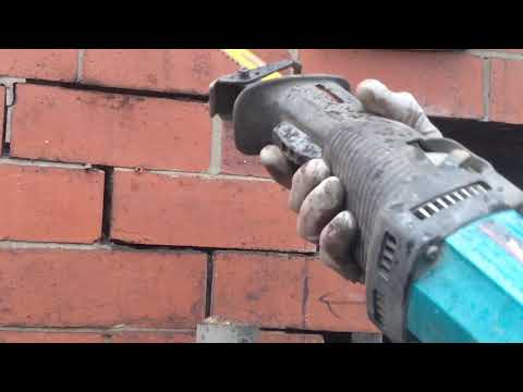 Reciprocating saw with DeWalt Dt2335 blade cutting out bricks.