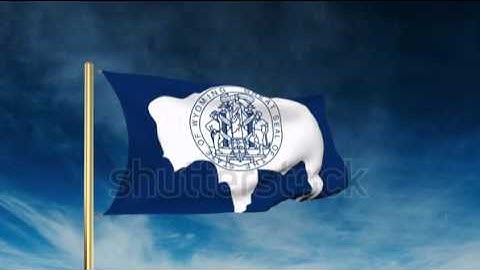 wyoming flag slider style. Waving in the win with cloud background animation Stock video by