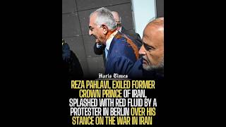 Reza Pahlavi, splashed with red fluid by a protester in Berlin over his stance on the war in Iran