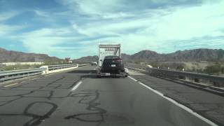 Chevrolet Volt towed on a  flatbed trailer behind a rented UHaul Truck
