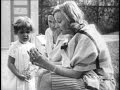 Greta Garbo playing with a child in the garden 1928