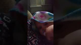baby points to viewers nose eyes and mouth then says bye and walks away in her diaper