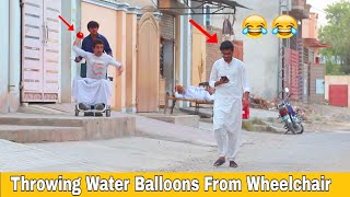 Throwing Water Balloons From Wheelchair  Throwing Water Balloons Prank Gone Funny Reactions