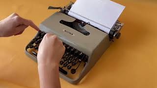 Olivetti Pluma 22 Gray Typewriter Typing - El Rastro Antiques Warehouses