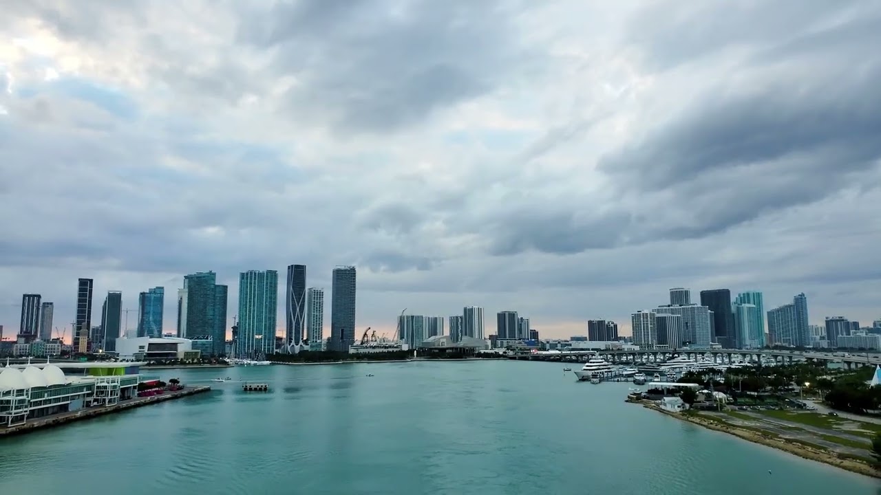 As dusk settles, the cruise ship drifts away from Miami’s glowing skyline