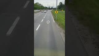 Riding a 2-floor bus, the front, top floor, going through a bus designated lane. Feel like driving!