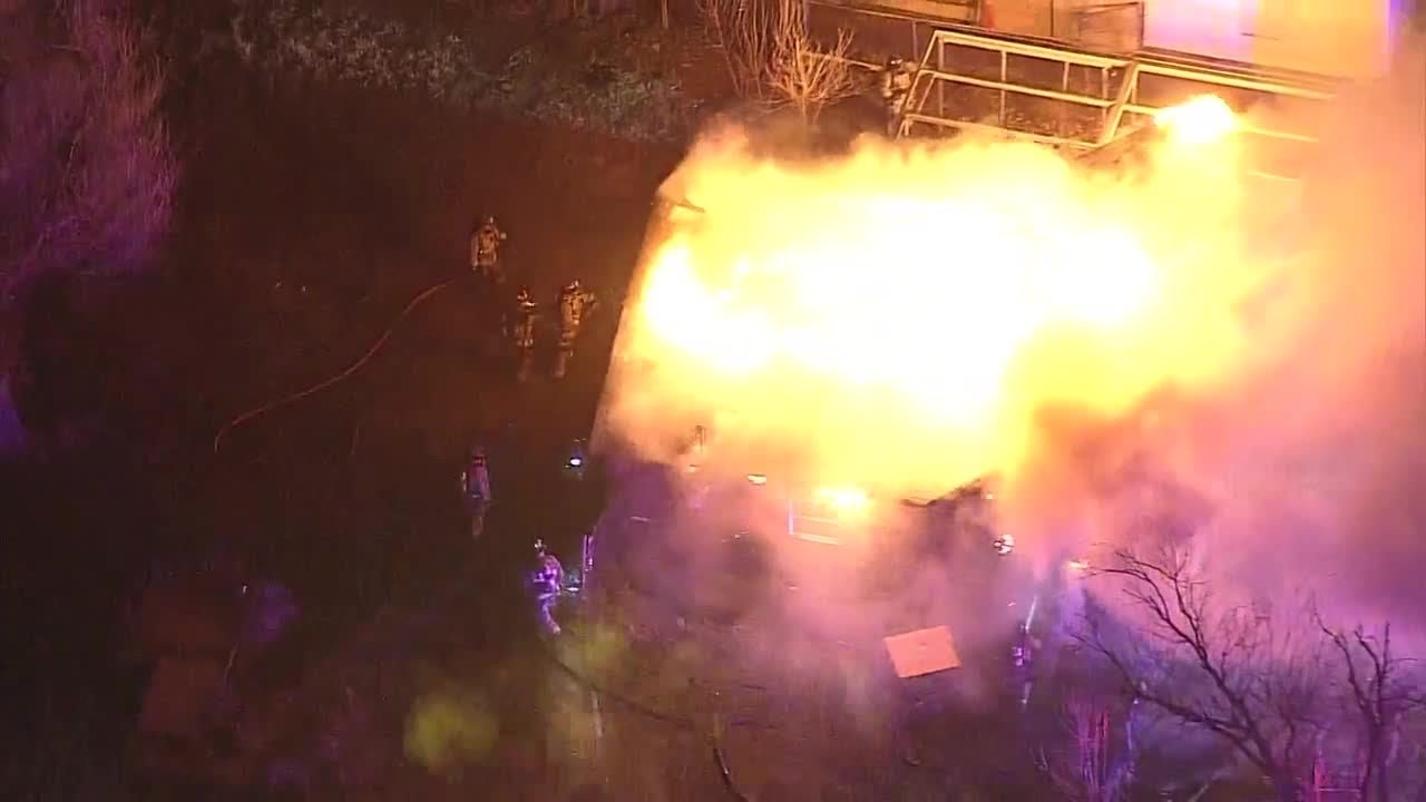 Large flames break out at multiple buildings Friday morning in