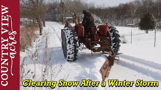 Plowing Snow with the rear blade on a Allis Chalmers.  Went good, till I got the tractor stuck.