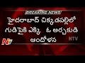 Priest climbs to temple top, threats to jump