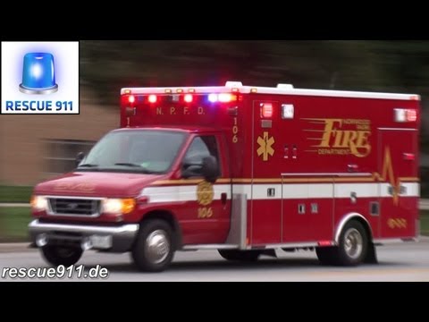 An ambulance of the Nordwood Park Fire Department (NPFD) responding past a CFD fire station in Chicago. Ein Rettungswagen des Nordwood Park Fire Department a...