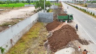 Fisrt Start New Project.Dozer pouring soil from the side of the road Filling Land on the Drain