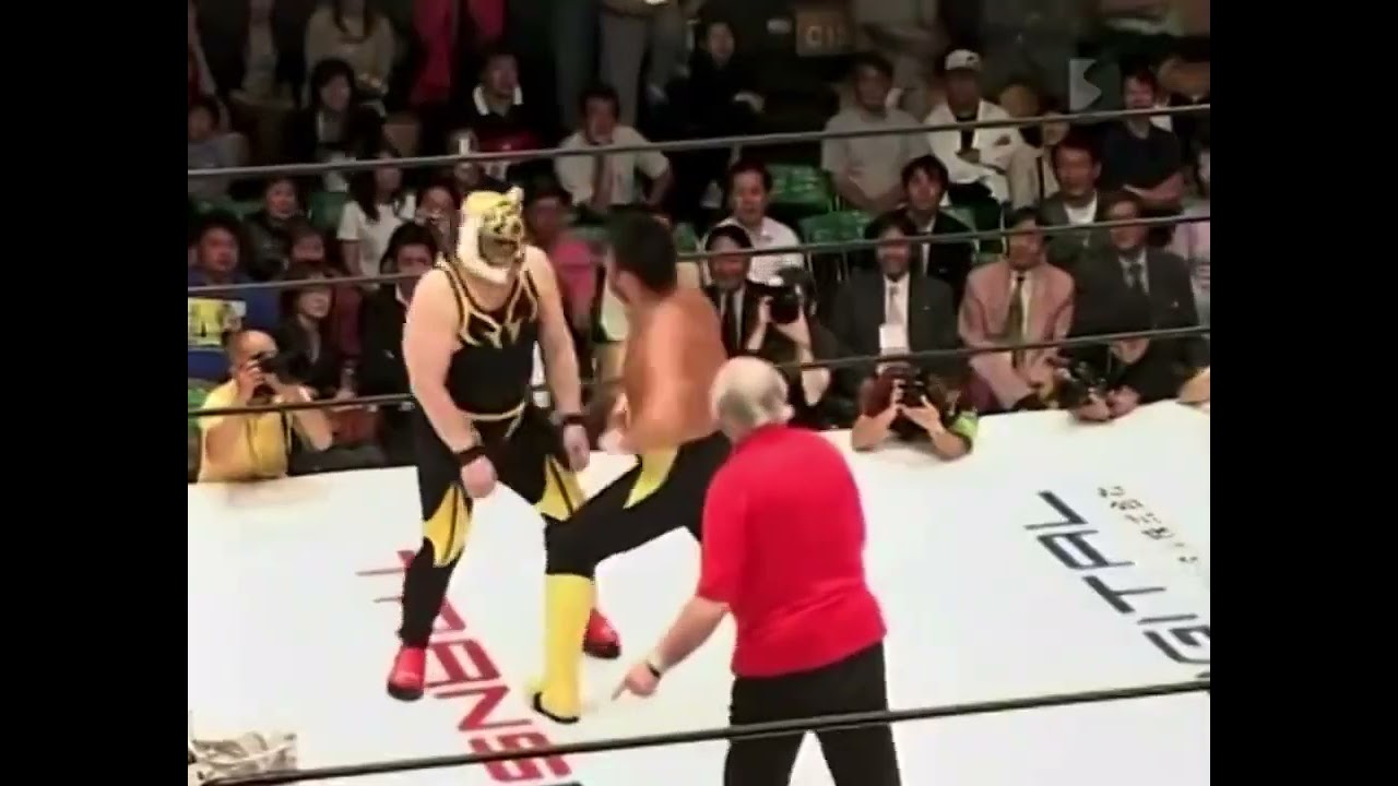 Kawada and the Original Tiger Mask Satoru Sayama trade strikes.