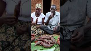 African Family Enjoying a Traditional Roasted Pangolin Feast.@FlavorHunts-ai