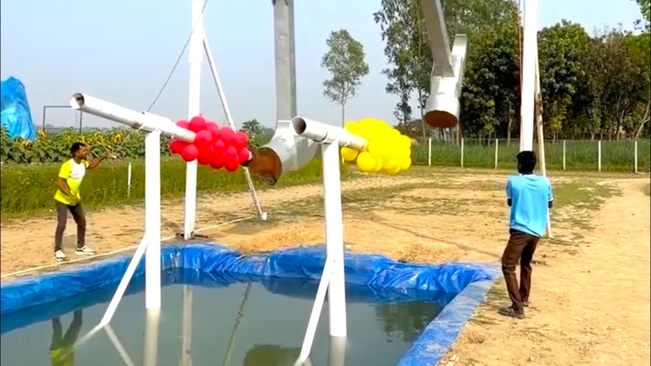 In the new strange game, two young men fight to win the prize at the end of the balloon bursting gam