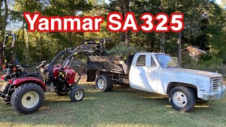 Yanmar SA325 tractor first time using grapple with Chevy R30 dump truck. Yanmar tractor