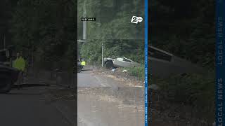 Two tow trucks remove a Tesla CyberTruck from a ditch on the side of Hwy 26 near the Jefferson ramp