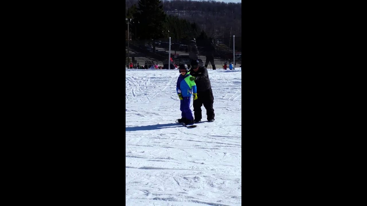 12 year old autistic  boy learning to snowboard