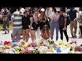 Hundreds gather to lay flowers at the site of the deadly Bondi Beach shooting