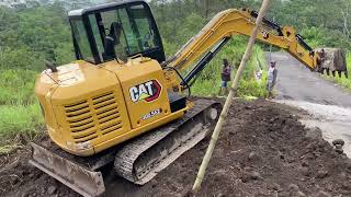 Caterpillar excavator works to make a road to enter the sand mine