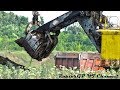 Old EKG-4.6 rope shovel loads dirt on KAMAZ-6520 trucks