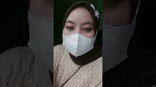 A Woman Is Live While Wearing A Mask And A Hijab.