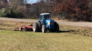 Allis Chalmers chisel plow tears up hay field