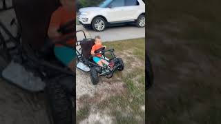Boy rides Go Kart around front yard then rides into driveway and hits front bumper of SUV truck