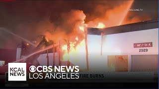 Firefighters tackle lingering hotspots after massive blaze engulfs Commerce building