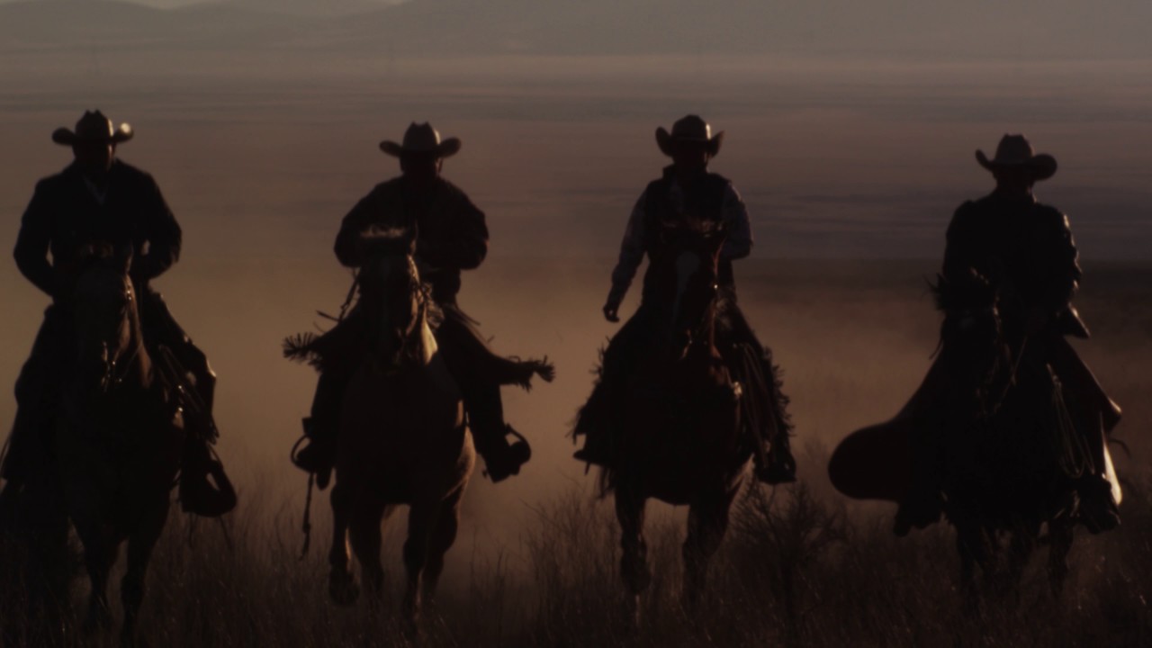 Slow motion panning shot of four cowboys riding horses - YouTube