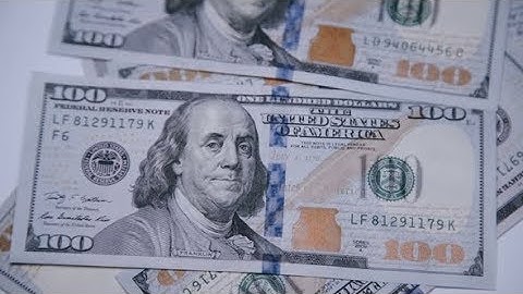 The Bills of 100 Dollars Falling on Rotating Background | Stock Footage - Videohive