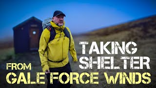 Taking shelter from gale force winds in mountain bothy.