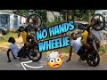 Doing no hands wheelie