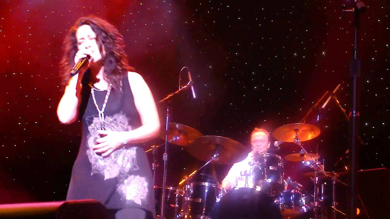 David Cassidy plays drums while Teri Coté performs "Brass in Pocket