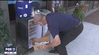 Winter Haven catering company stocks refrigerator with free food for the homeless