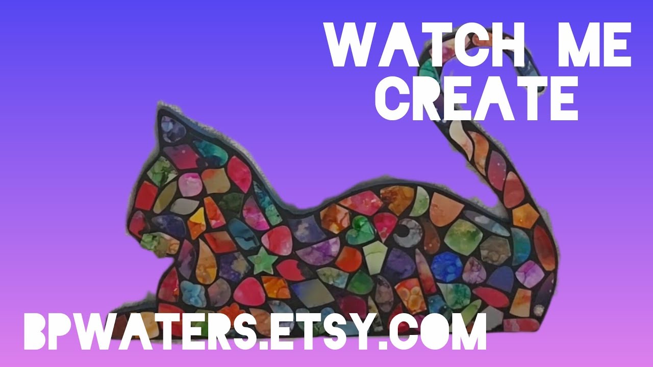 Creating an alcohol ink wall art piece, cat lying down