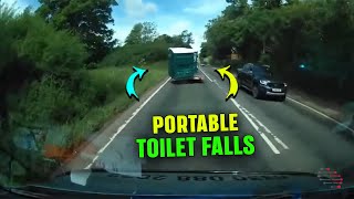 Portable Toilet Slides Off Trailer, Crashes Into Car