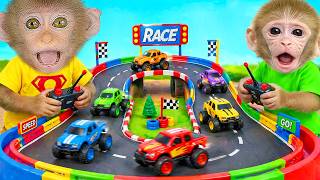 Monkey Lily and her little brother happily play a toy car racing game! | LILY MONKEY TDC