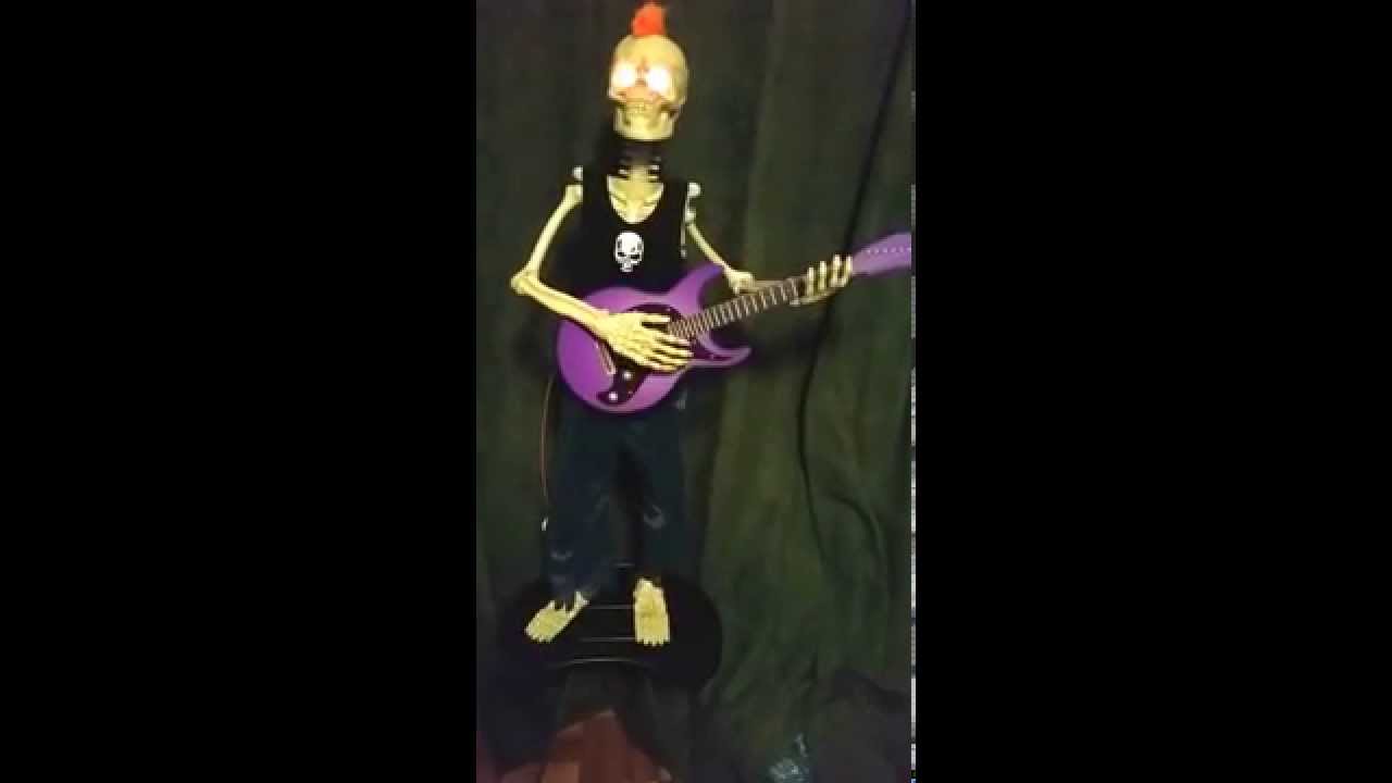 Animated Skeleton Rockstar with Orange Mohawk Halloween Prop
