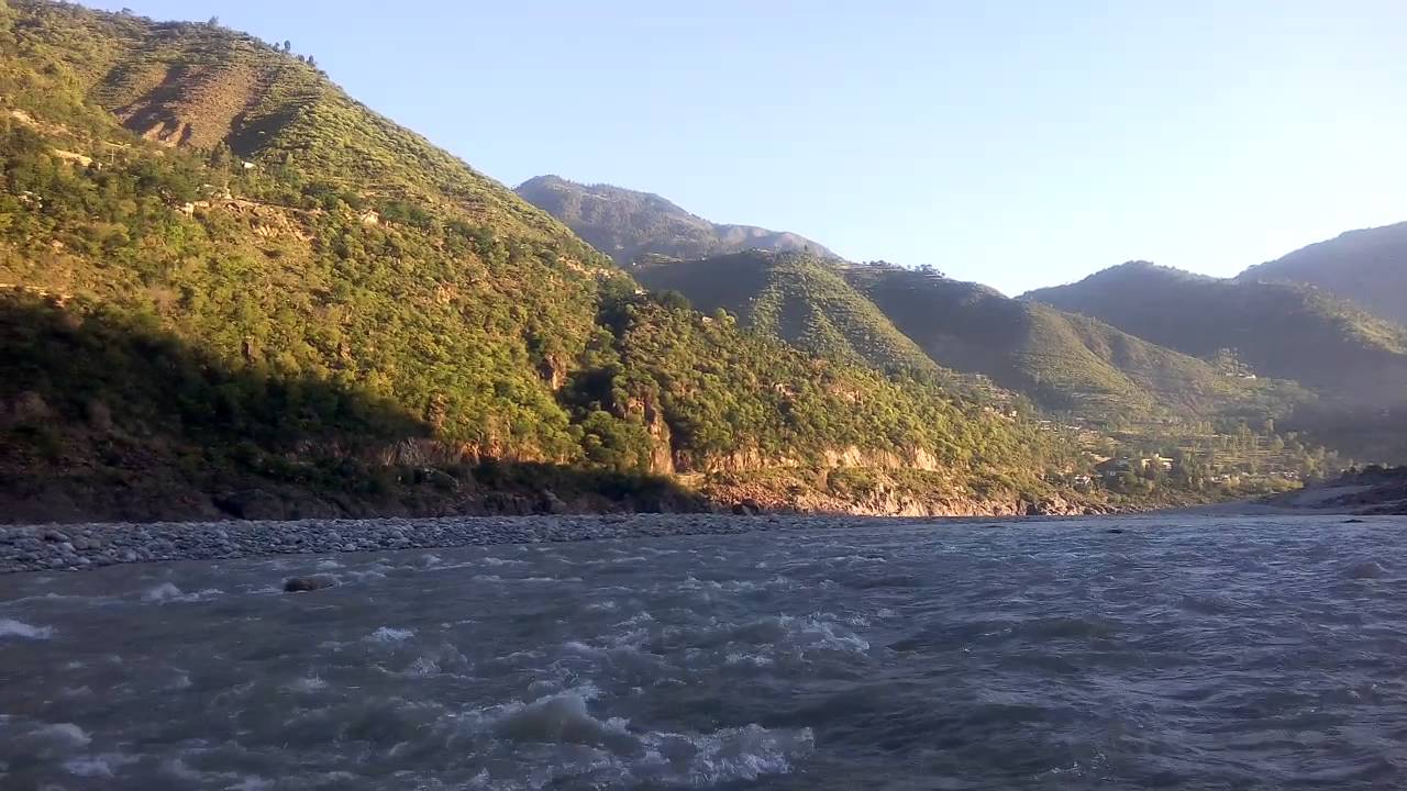 Beautiful Flowing River And Mountains With Sunshine In Pakistan adventure travel agency