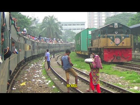 southern railway off peak times Fully loded Dewangang commuter train crossing freight train in Airport railway station, Bangladesh