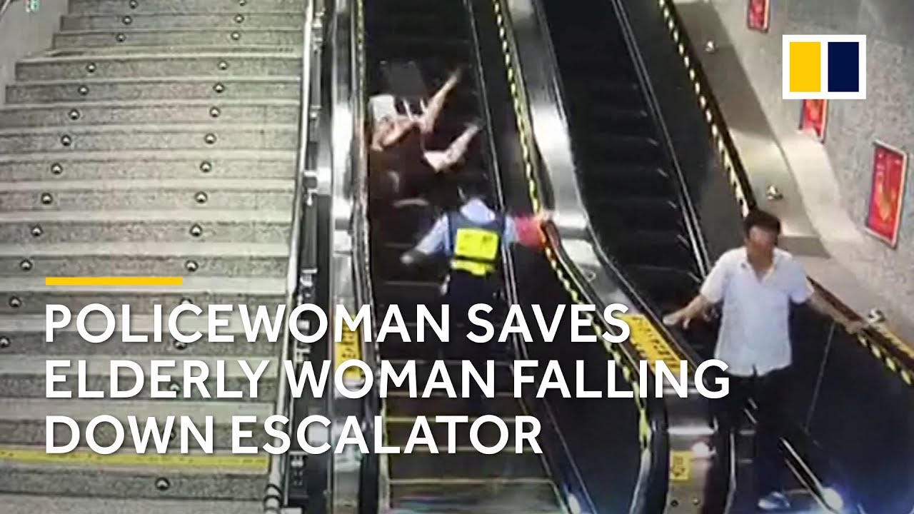 Policewoman saves elderly woman falling down escalator YouTube