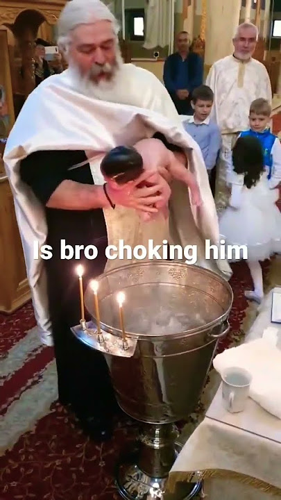 Priest dunking kid in water