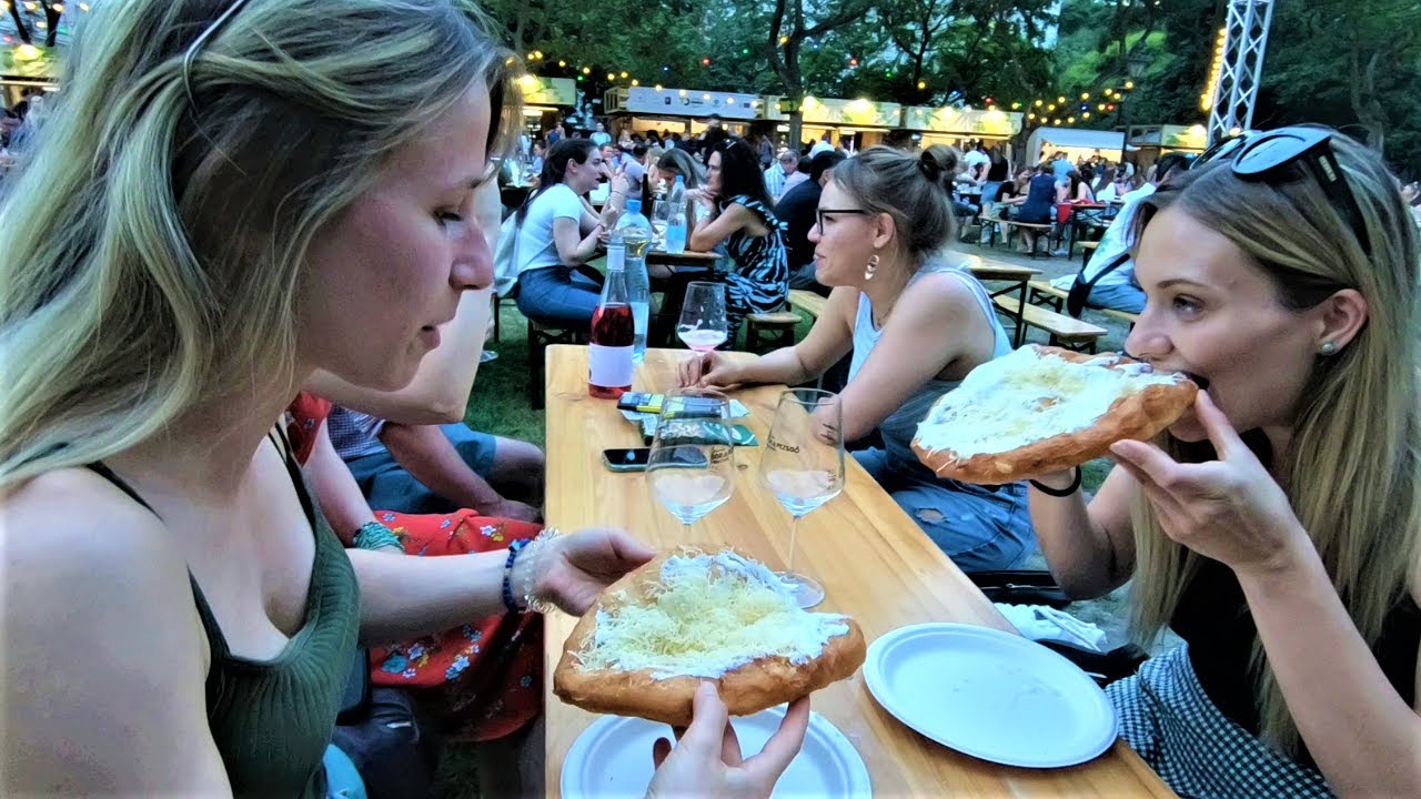 Street Food in Budapest, Hungary. Preparing, Cooking and Eating Traditional 'Langos'