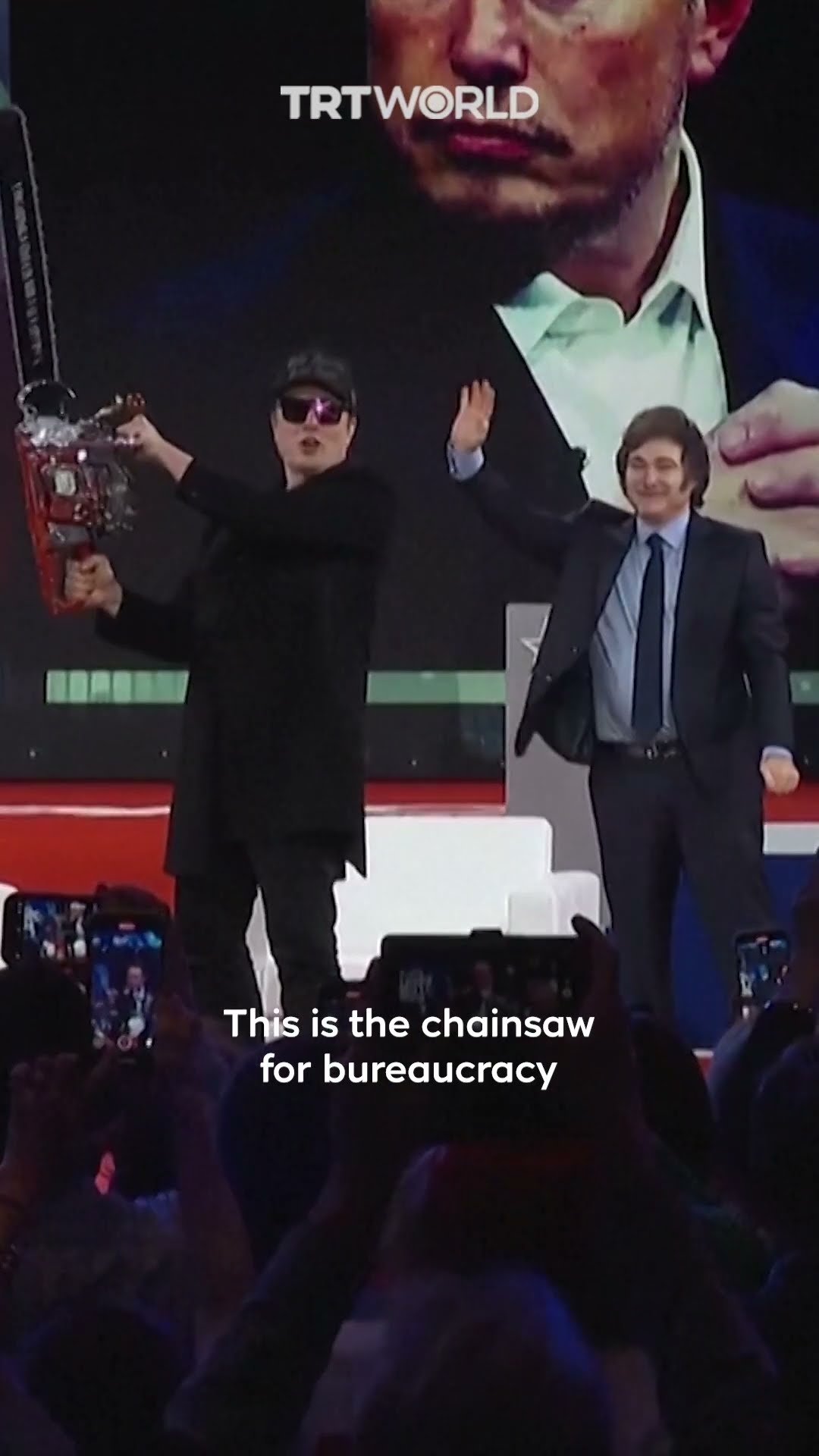 Elon Musk wields 'chainsaw for bureaucracy' on stage
